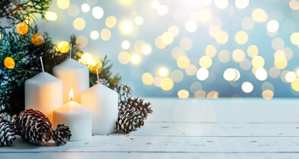 istock Advent white candles with decor in shiny lights 1442249565