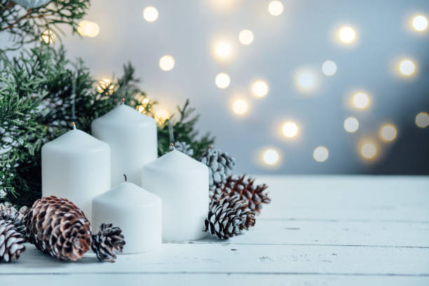 istock Advent white candles with decor in shiny lights 1442249569