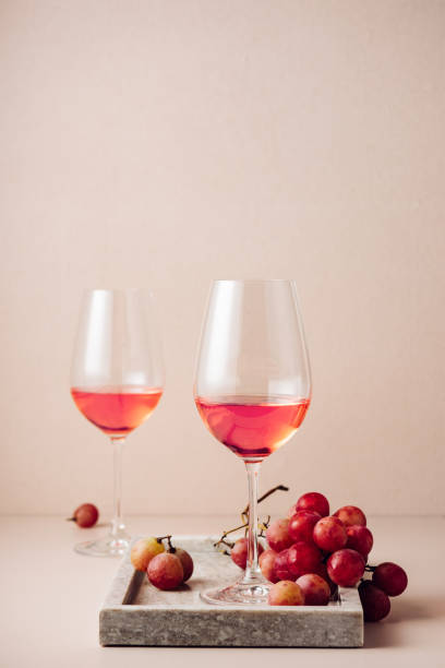 istock Two glasses of rose wine and red grapes. 1442251378