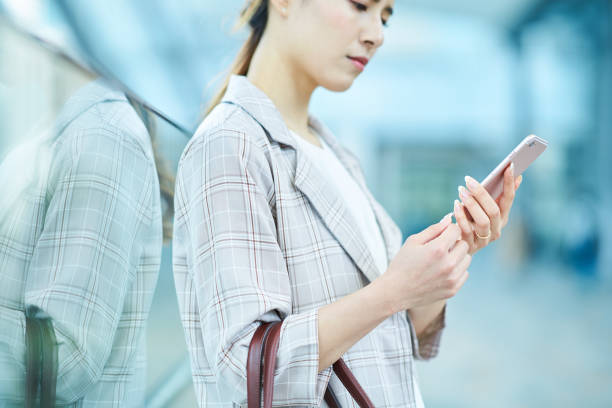 istock woman looking at a smartphone screen with a troubled expression 1442255158