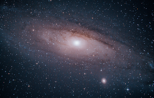 Andromeda is our nearest spiral galaxy neighbor at about 2.5 million light years away, and contains about 1 billion stars. It is larger but less dense than our own Milky Way.