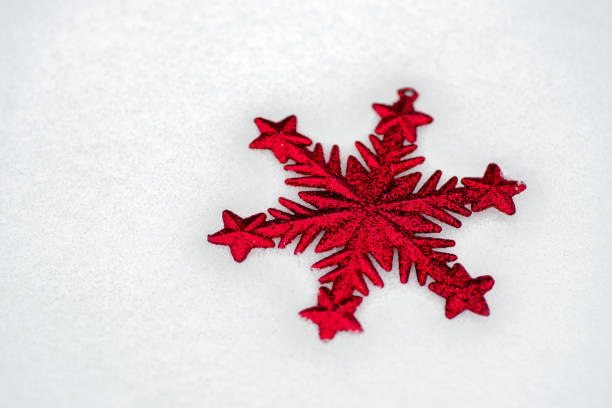 Red white ornamental star in the snow. Christmas bacground
