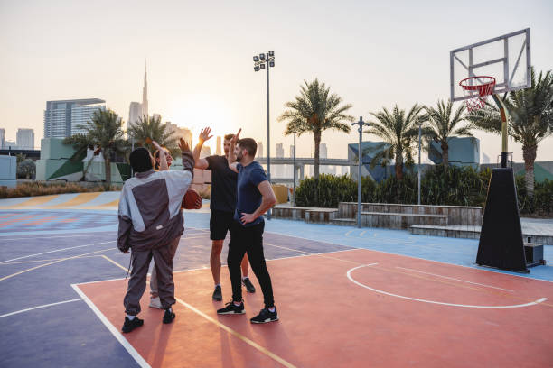 istock Group Of Friends Doing A High Five Outdoors In Dubai 1442258354