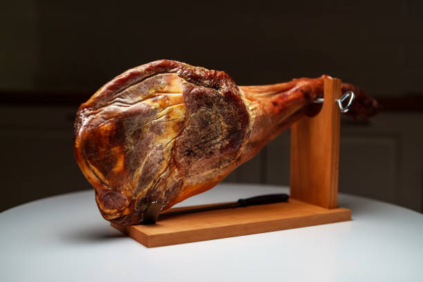 istock Dry-cured spanish ham. Jamon on a wooden stand. 1442259026