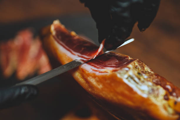 istock Chef cutting dry-cured spanish ham Jamon. 1442259074