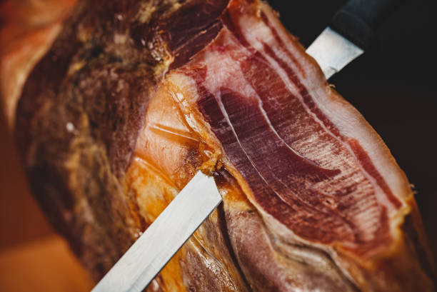 istock Dry-cured spanish ham Jamon with knife. 1442259127