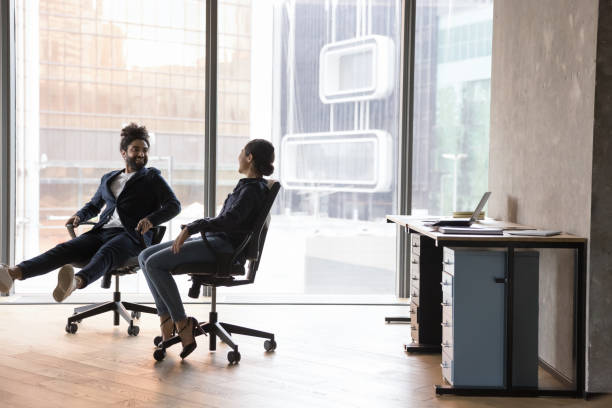 istock Indian workmates friends, have fun spend break seated in chairs 1442259687