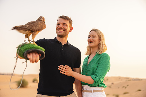 Man handling a falcon in Dubai.