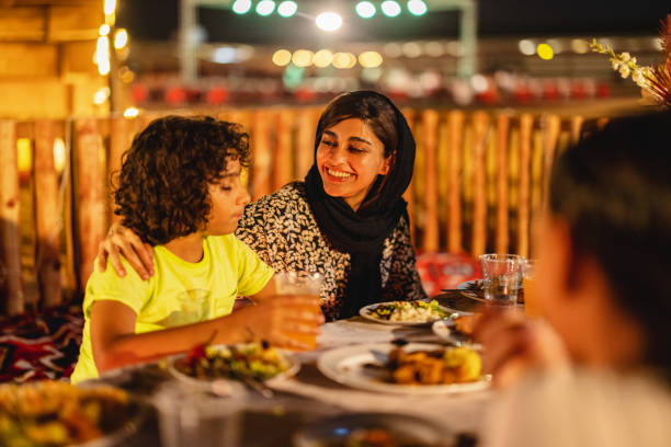 istock Middle Eastern Mother Smiling At Her Son At Dinner In Dubai 1442260906