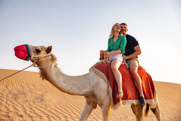 istock Happy Tourists On A Camel Ride in Dubai 1442260956