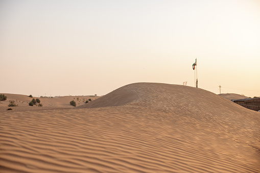 Shot of a peaceful landscape in the Dubai desert at sunset. There is no one on the photo.