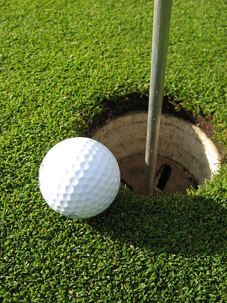 istock A white golf ball tight next to the hole 144226695