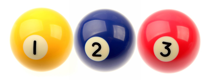Three pool balls on plain background