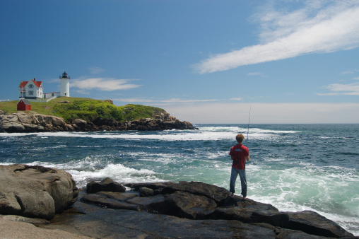 A boy fishing off the coast at Nubble Lighthouse in Maine. See my other lighthouses: 