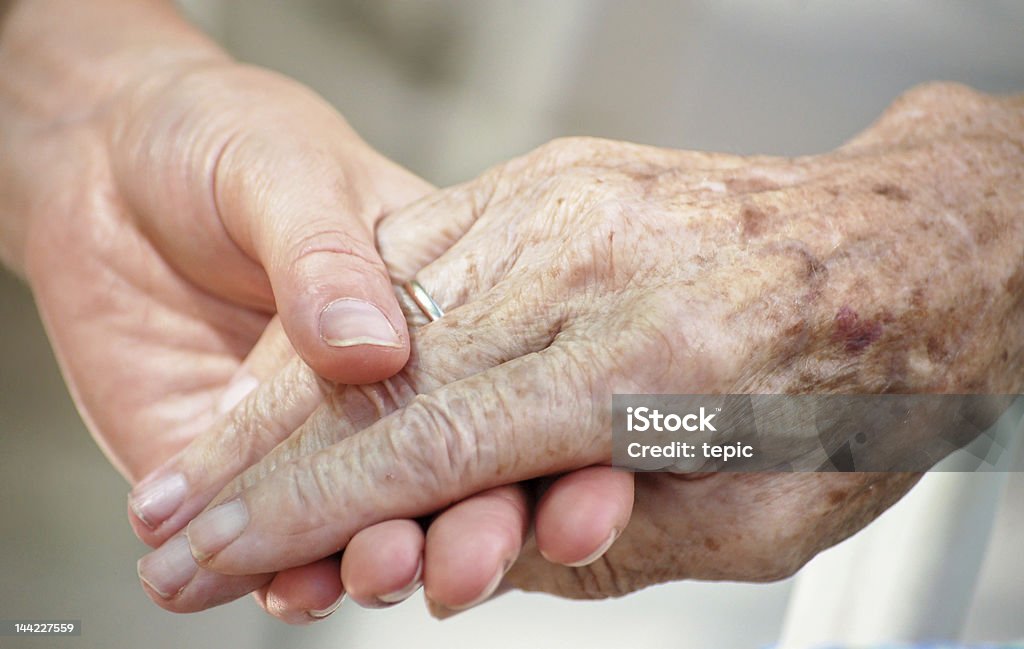 Old and Young Woman gives grandma her hand Guidance Stock Photo