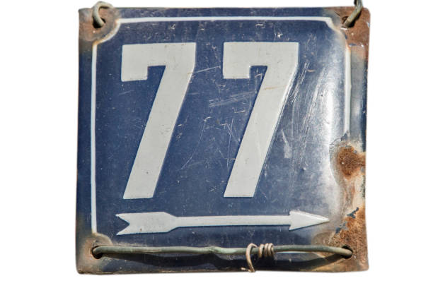 istock Weathered enamelled plate number 77 1442275716