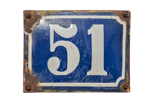 Weathered grunge square metal enameled plate of number of street address with number 51 isolated on white background