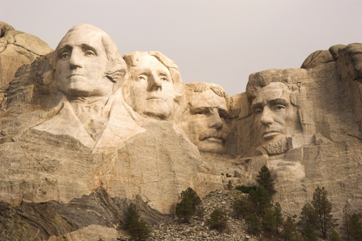 Carved sculptures of U.S. presidents George Washington, Thomas Jefferson, Theodore Roosevelt and Abraham Lincoln.