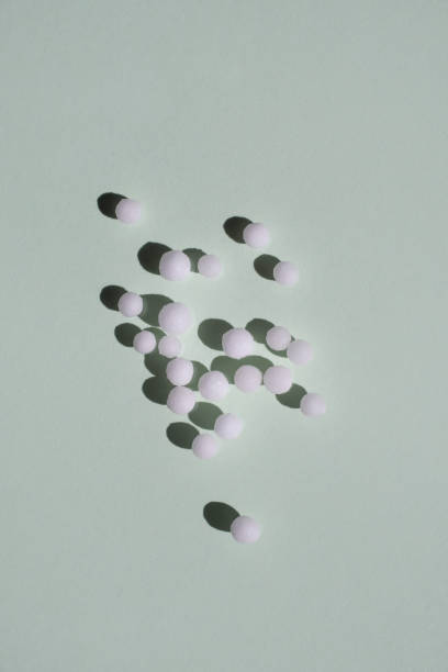 istock The homeopathic pills are scattered on a light green background. Flat styling, space for text. Concept of alternative medicine. 1442277681