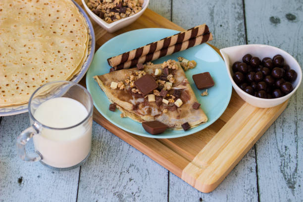 istock Crepes with chocolate on cutting board with ingredients 1442277820