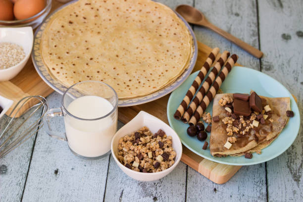 istock Crepes with chocolate on cutting board with ingredients 1442278078