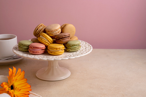 Macaroons colorful cookies. Macarons french sweet dessert, top view, pink background