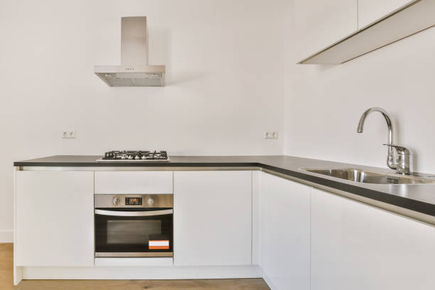 istock a kitchen with white cabinets and a sink and oven 1442281407