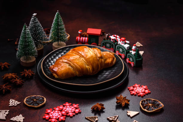 istock Beautiful different Christmas decorations and croissant on a brown concrete table 1442282420
