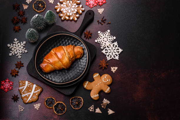 istock Beautiful different Christmas decorations and croissant on a brown concrete table 1442282445