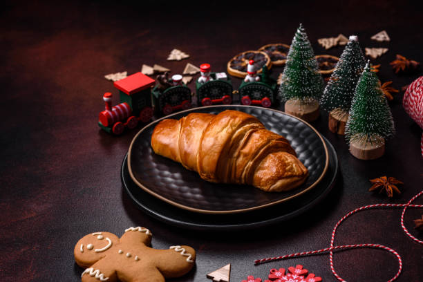 istock Beautiful different Christmas decorations and croissant on a brown concrete table 1442283052