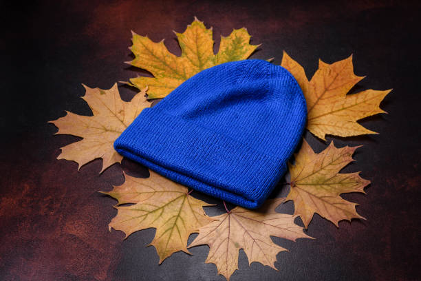 istock Blue knitted warm cap on dark brown concrete background 1442283268