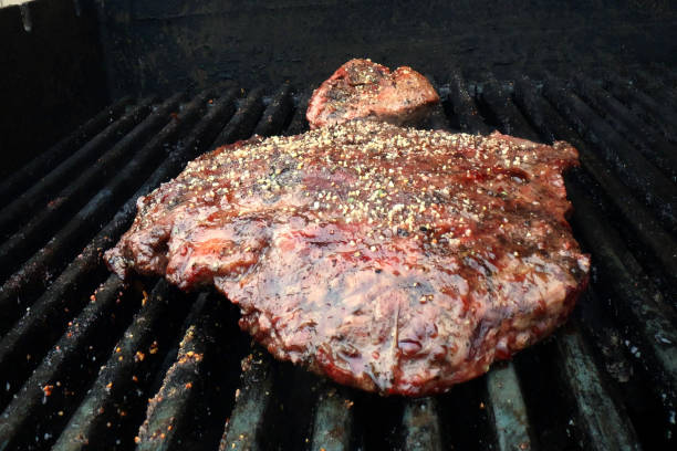 istock Cooking flank steak and filet on the grill 1442283675