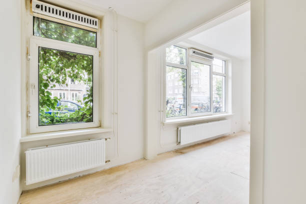 istock a living room with two windows and a wood floor 1442285656