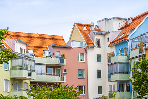 Colorful apartment complex around a small park.