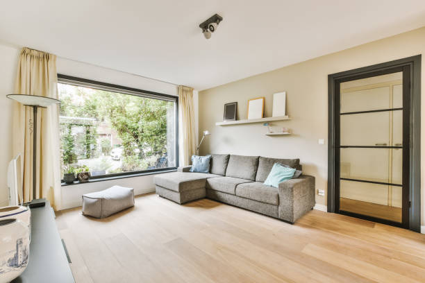 istock a living room with a couch and a large window 1442287357
