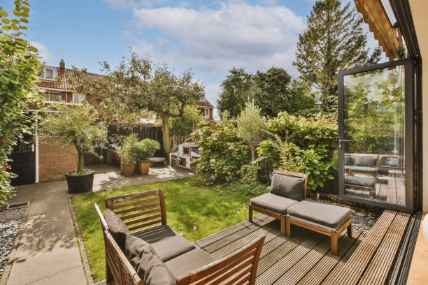 istock a backyard with a couch and chairs and a garden 1442287400