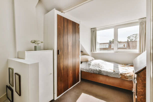 istock a bedroom with a bed and a wooden closet 1442287436