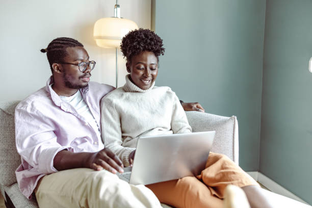 istock Young African-American couple using laptop at home 1442290594