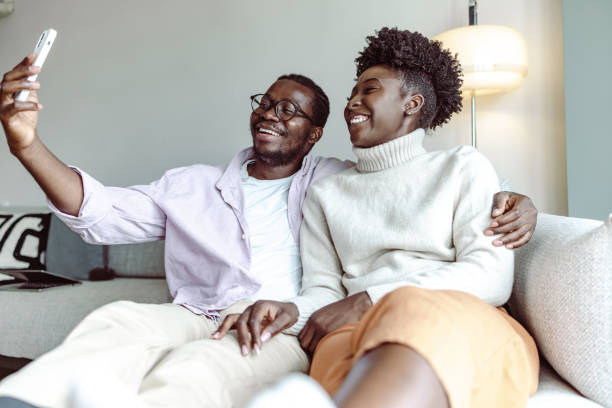 istock Happy African-American couple using smart phone and taking selfie 1442290630