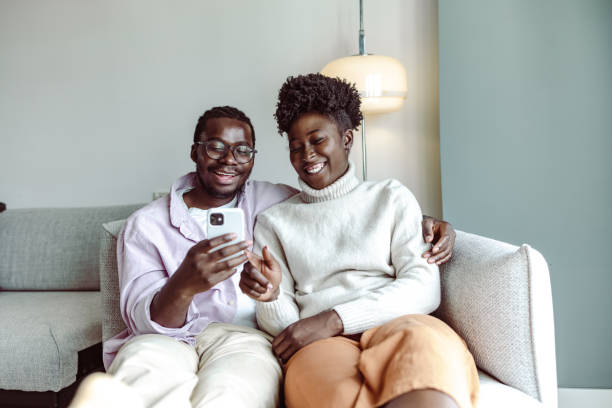 istock Happy African-American couple using smart phone at home 1442290632