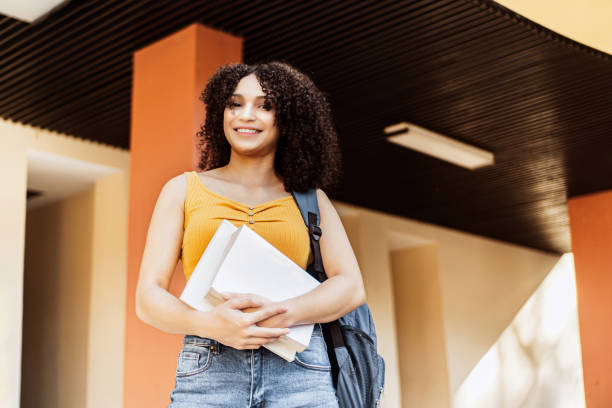 istock happy latin american student holding books. 1442292344