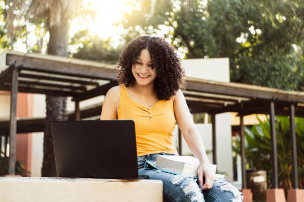 istock Student girl working with a laptop in a green park 1442293077