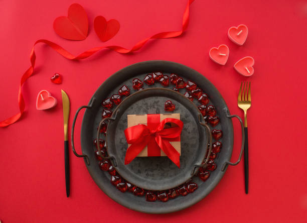 istock Banner. Romantic dinner. Vintage plates, festive table setting with a gift box on a red background. The concept of love. Valentine's Day. 1442293164