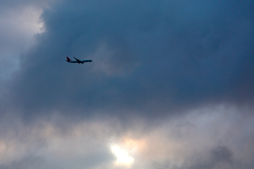 Passengers commercial airplane flying in sunset