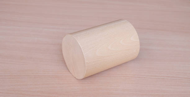 istock Wooden roller cylinder geometric model shape on wood table background. Perfect geometry concept 1442293963