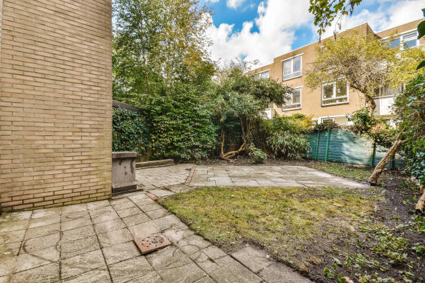 istock a backyard with a brick wall and a blue fence 1442294994