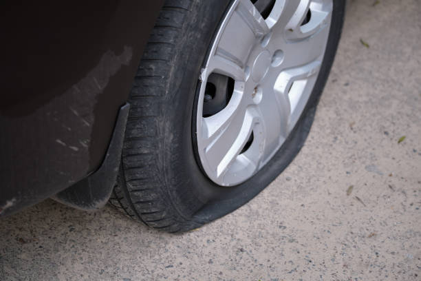 istock Car with punctured flat tire parked on roadside 1442295488