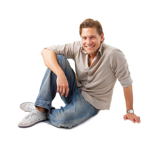 istock Happy young man sitting and smiling 144229622