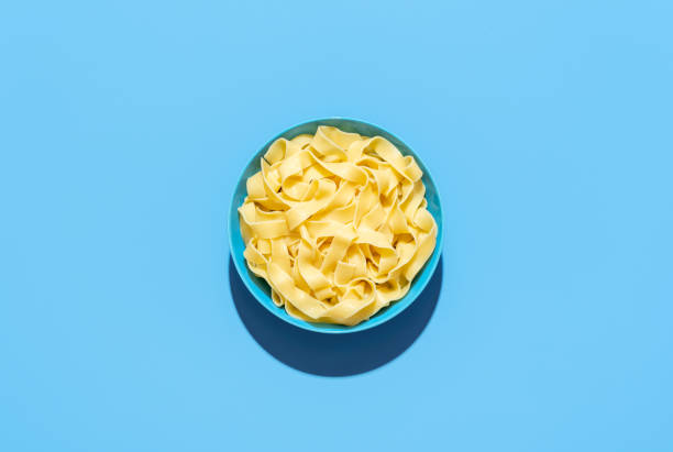 istock Pappardelle pasta bowl isolated on a blue background 1442297986