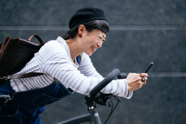 istock Smiling Woman Using A Mobile Phone In The City 1442299296